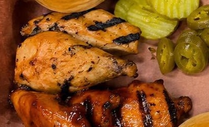 Smoked chicken pieces with grill marks next to glazed wings